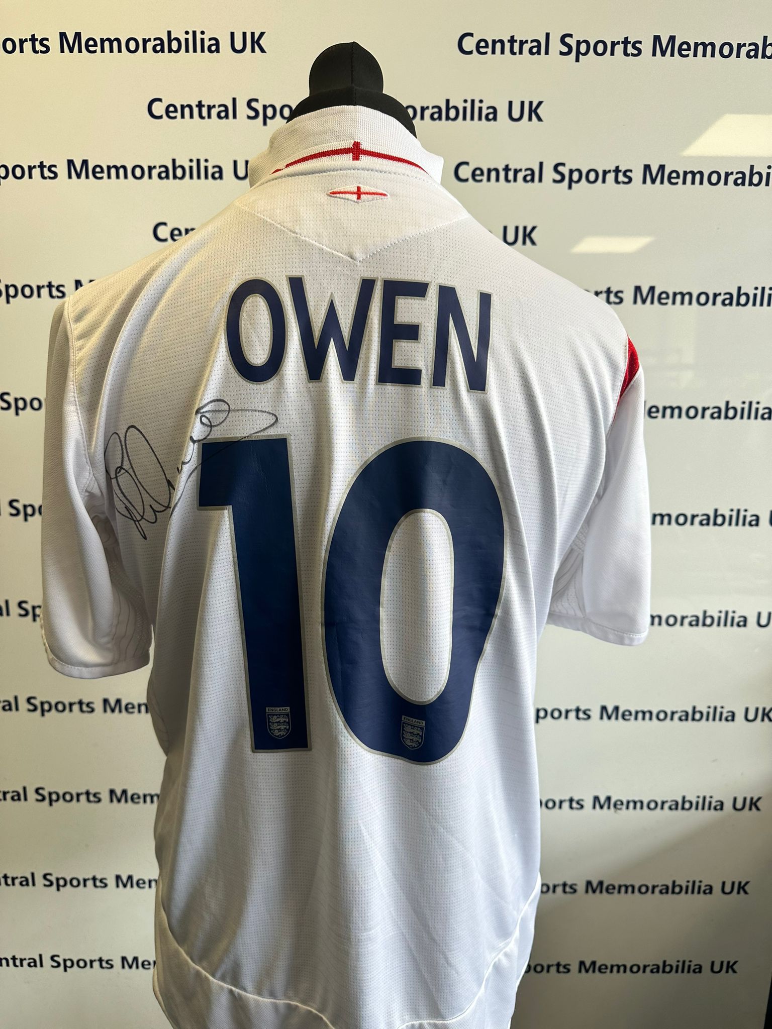 England Replica Shirt Signed front and back by Michael Owen.  Size L (Adult)